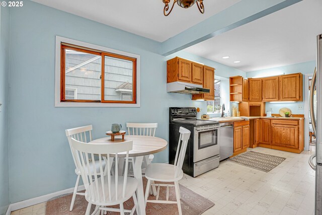 kitchen with stainless steel appliances, under cabinet range hood, a sink, baseboards, and open shelves