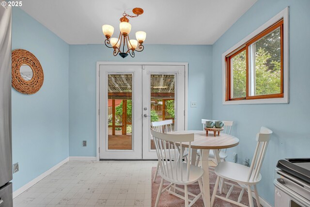 dining room with healthy amount of natural light, a chandelier, french doors, and tile patterned floors