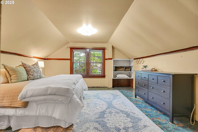 bedroom with carpet and vaulted ceiling
