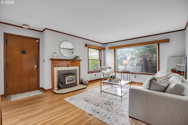 living room with ornamental molding, wood finished floors, and baseboards