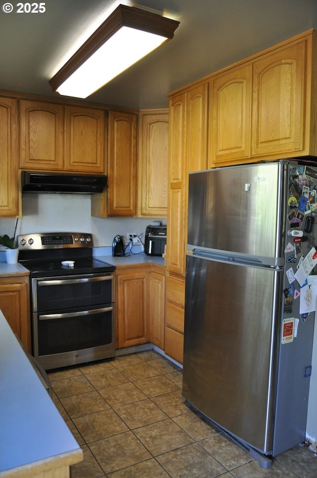 1529 Brentwood Ave, Eugene, OR 97404 - kitchen with stainless steel appliances, under cabinet range hood, light countertops, and tile patterned flooring