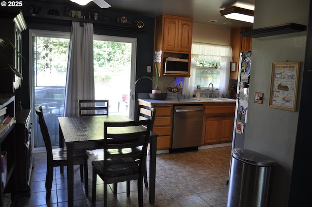 1529 Brentwood Ave, Eugene, OR 97404 - kitchen with stainless steel appliances, brown cabinets, and tile patterned flooring