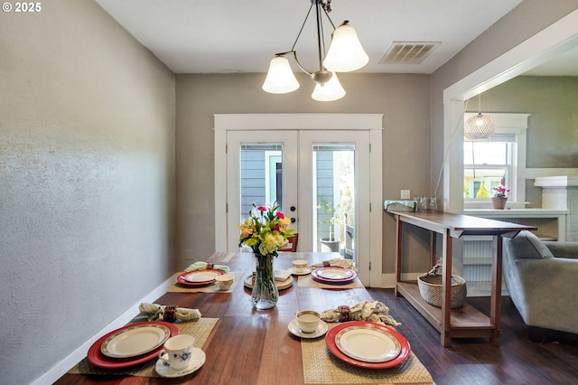 318 Koons St, Silverton, OR 97381 - dining room featuring a chandelier, wood finished floors, baseboards, and french doors