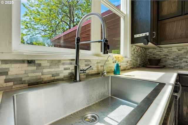 318 Koons St, Silverton, OR 97381 - kitchen view of dark brown cabinets, tasteful backsplash, a sink, and light countertops