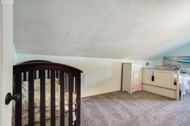 318 Koons St, Silverton, OR 97381 - unfurnished bedroom with a textured ceiling, carpet flooring, and vaulted ceiling
