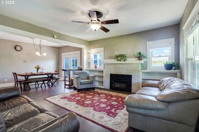 318 Koons St, Silverton, OR 97381 - living room featuring a tile fireplace, a ceiling fan, wood finished floors, and french doors