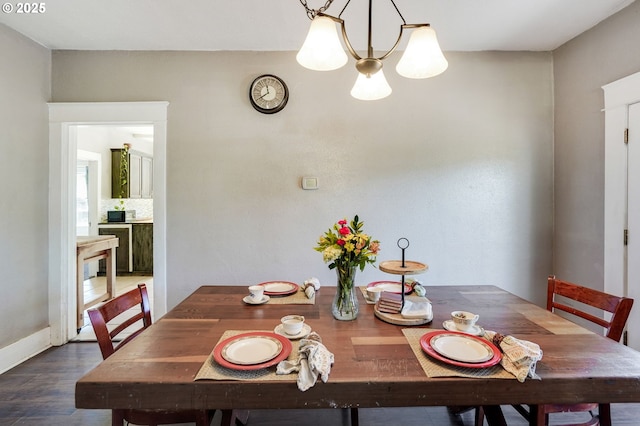 318 Koons St, Silverton, OR 97381 - dining space with a chandelier, wood finished floors, and baseboards