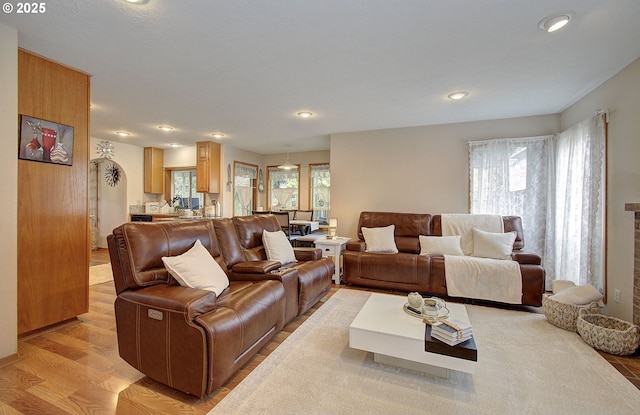 living area with recessed lighting and light wood-style flooring