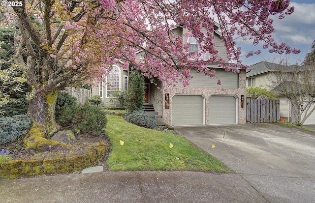 obstructed view of property featuring concrete driveway, a garage, fence, and brick siding