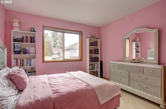 bedroom featuring light carpet