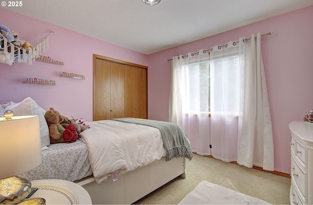 bedroom featuring a closet and light carpet