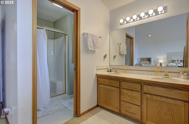 bathroom featuring a shower stall, ensuite bath, and a sink