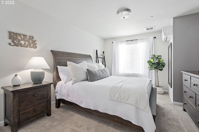 bedroom featuring light carpet and a wall mounted air conditioner