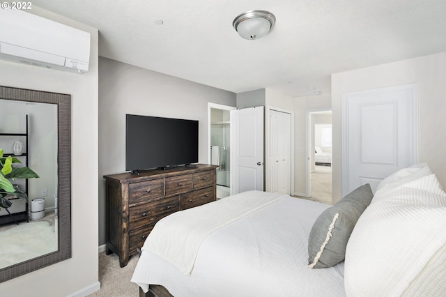 bedroom featuring ensuite bathroom, light carpet, and a wall mounted air conditioner