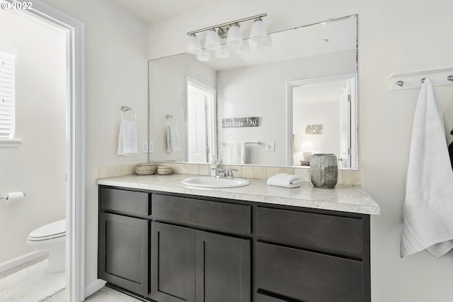 bathroom featuring vanity and toilet