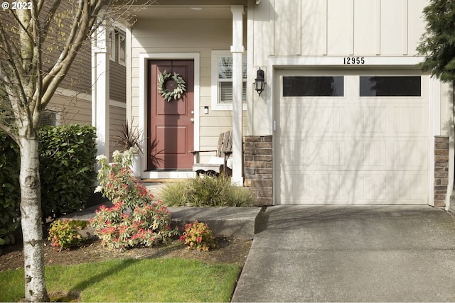 doorway to property with a garage