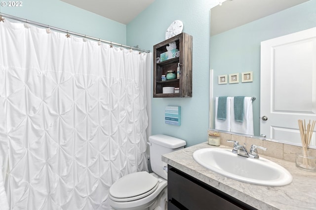 bathroom with vanity, curtained shower, and toilet