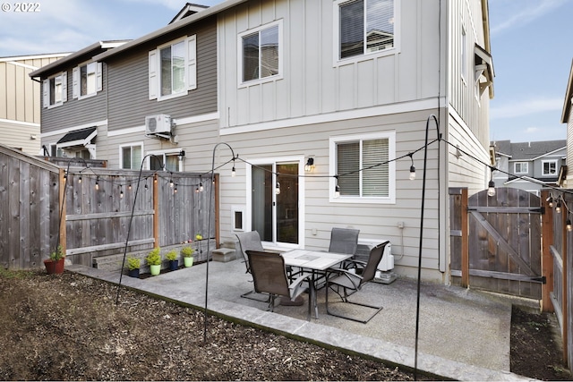 rear view of property with a patio and a wall mounted AC