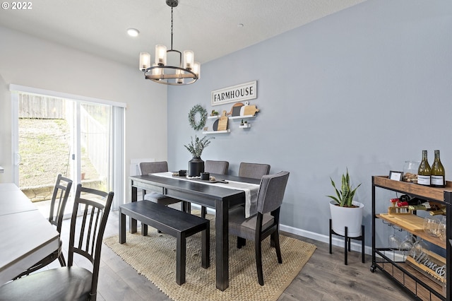 dining area with a chandelier and dark hardwood / wood-style flooring