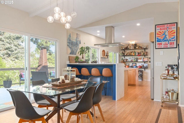 dining area with indoor wet bar, recessed lighting, lofted ceiling, and light wood finished floors