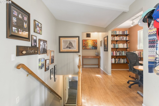 home office with vaulted ceiling with beams and wood finished floors