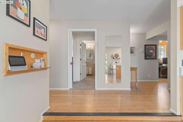 hall featuring baseboards and wood finished floors