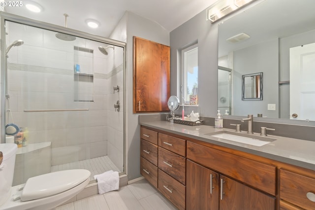 full bathroom with vanity, a stall shower, and tile patterned floors