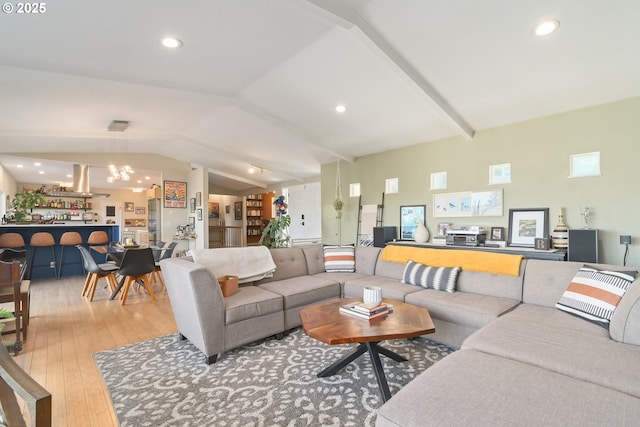 living area with a chandelier, vaulted ceiling, light wood-style flooring, and recessed lighting