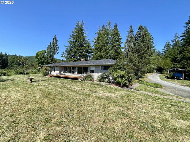 54824 Robinson Rd, Coquille, OR 97423 - single story home with a deck, a front lawn, and a chimney