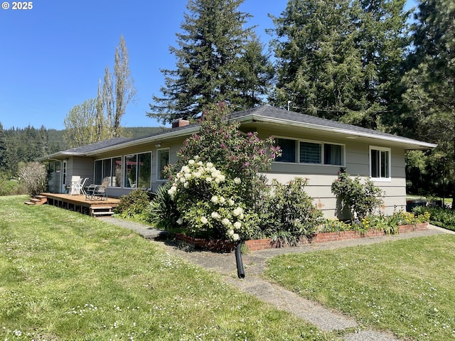 54824 Robinson Rd, Coquille, OR 97423 - view of front of home featuring a front lawn, a wooden deck, and a chimney