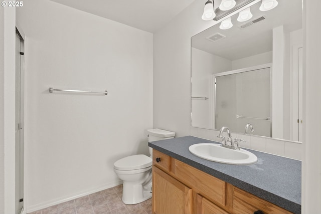 bathroom with a shower with shower door, toilet, and vanity