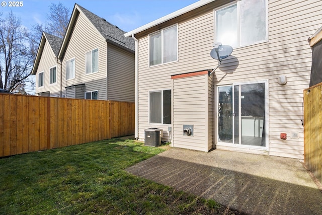 back of property featuring a patio area, a lawn, and central AC