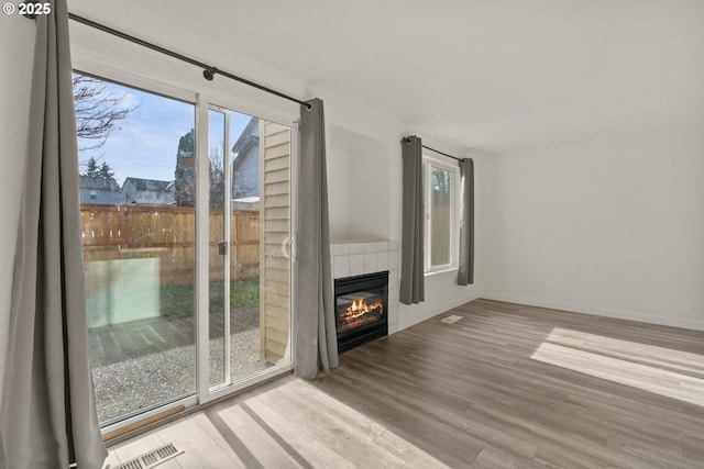 unfurnished living room featuring a fireplace and light wood-type flooring