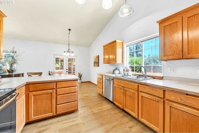 1041 Irving Rd, Eugene, OR 97404 - kitchen with appliances with stainless steel finishes, light wood-style floors, french doors, light countertops, and hanging light fixtures