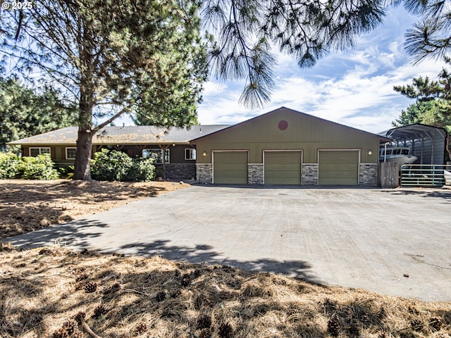 10160 NW Gordon Rd, Cornelius, OR 97113 - view of front of house with stone siding, driveway, an attached garage, and a carport