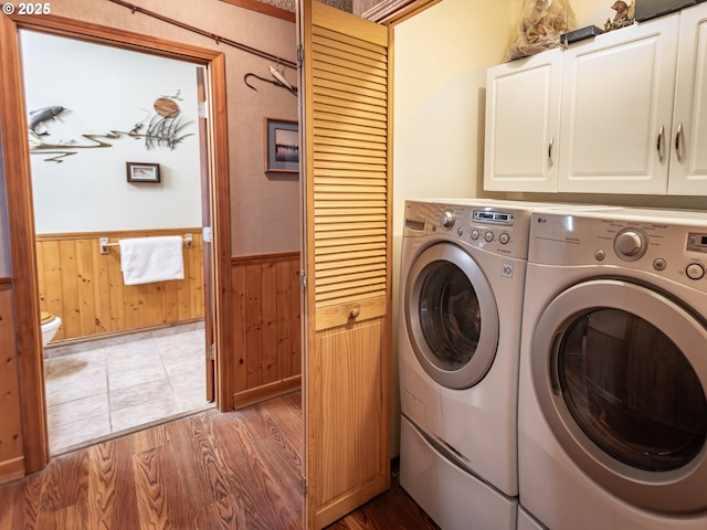 10160 NW Gordon Rd, Cornelius, OR 97113 - laundry room featuring cabinet space, wainscoting, separate washer and dryer, wooden walls, and wood finished floors