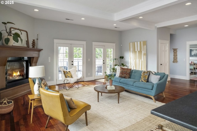 living area with a glass covered fireplace, wood finished floors, french doors, beam ceiling, and recessed lighting