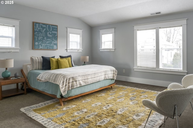 bedroom featuring lofted ceiling, baseboards, visible vents, and carpet flooring