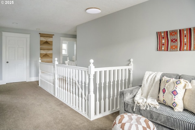 interior space featuring carpet and an upstairs landing