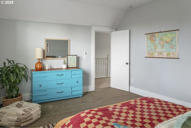 bedroom featuring lofted ceiling, baseboards, and dark carpet