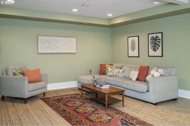 living area with recessed lighting, a textured ceiling, baseboards, and wood finished floors