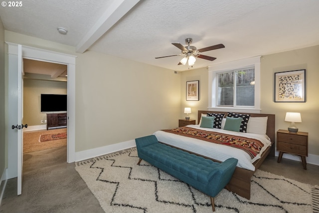 bedroom with ceiling fan, baseboards, and a textured ceiling