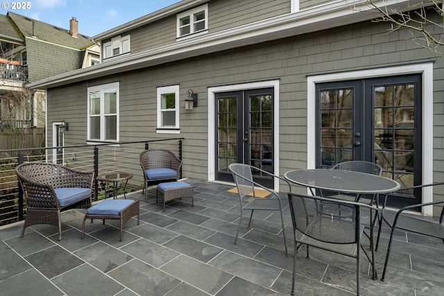 view of patio featuring fence and french doors