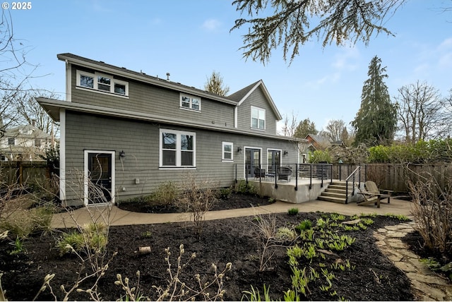 back of property featuring a patio, fence, and a wooden deck