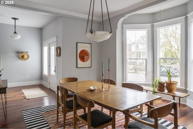 dining area with crown molding, baseboards, and wood finished floors