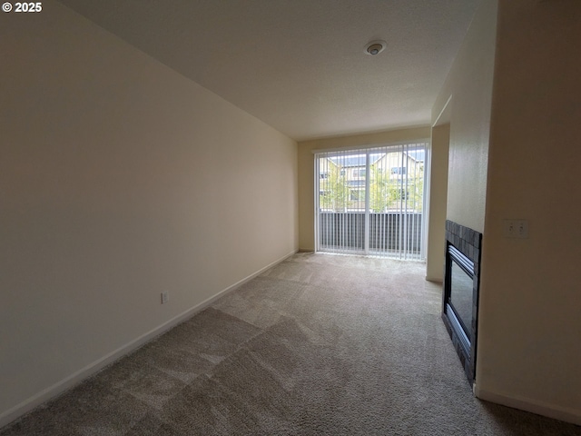 3159 SW Jaden Dr, Beaverton, OR 97003 - unfurnished living room with carpet floors, baseboards, and a fireplace