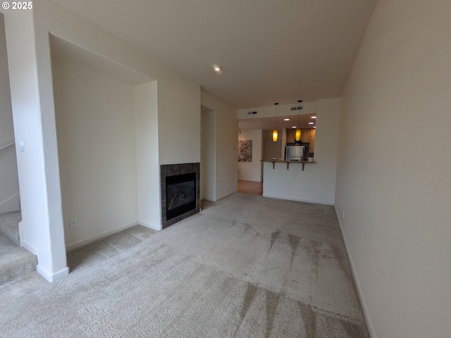 3159 SW Jaden Dr, Beaverton, OR 97003 - unfurnished living room with light carpet, baseboards, and a fireplace