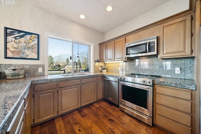 kitchen with tasteful backsplash, tile countertops, dark wood-style floors, stainless steel appliances, and a sink