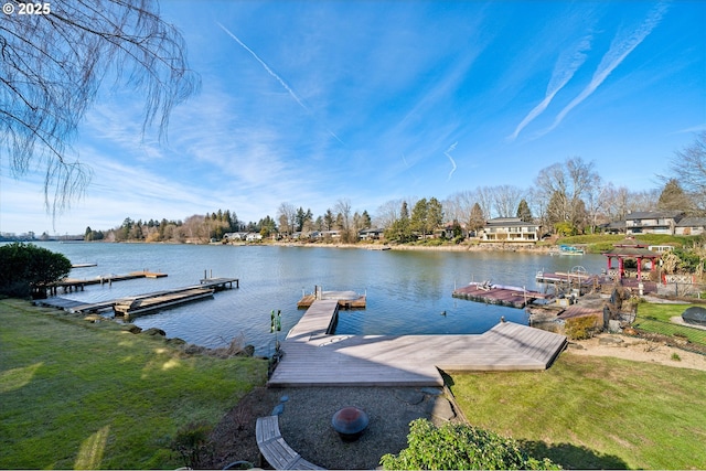 dock area with a lawn and a water view