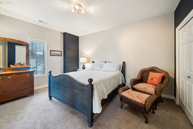 bedroom featuring light colored carpet, visible vents, and baseboards